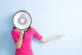 A woman holding a megaphone in front of her face