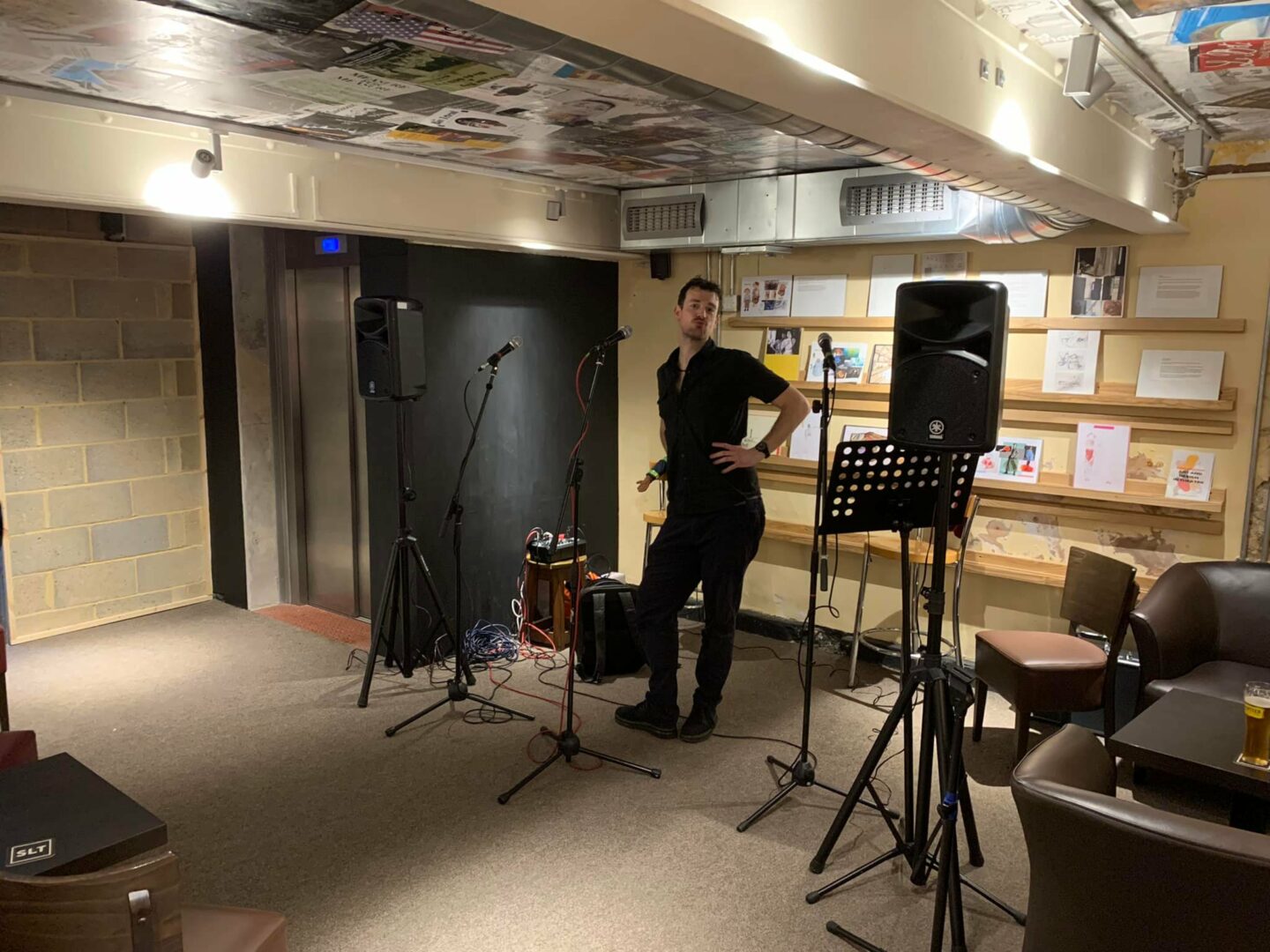 Photo of the bar with a man in front of microphones