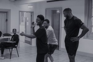Rehearsal image of actors dancing