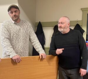 Two actors standing at an imaginary bar