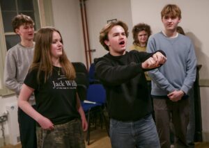 Five young actors in rehearsal