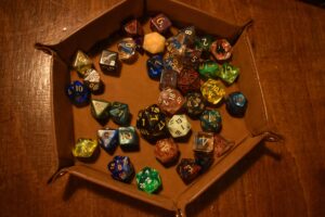 Dungeons and Dragons dice in a wooden tray