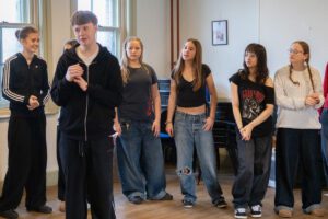 Four young actors in rehearsal