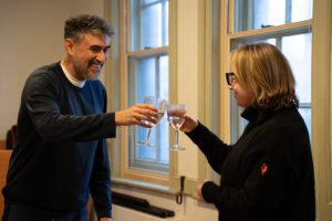 Man and woman toast each other with wine