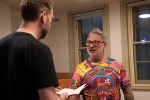 Two men standing talking 