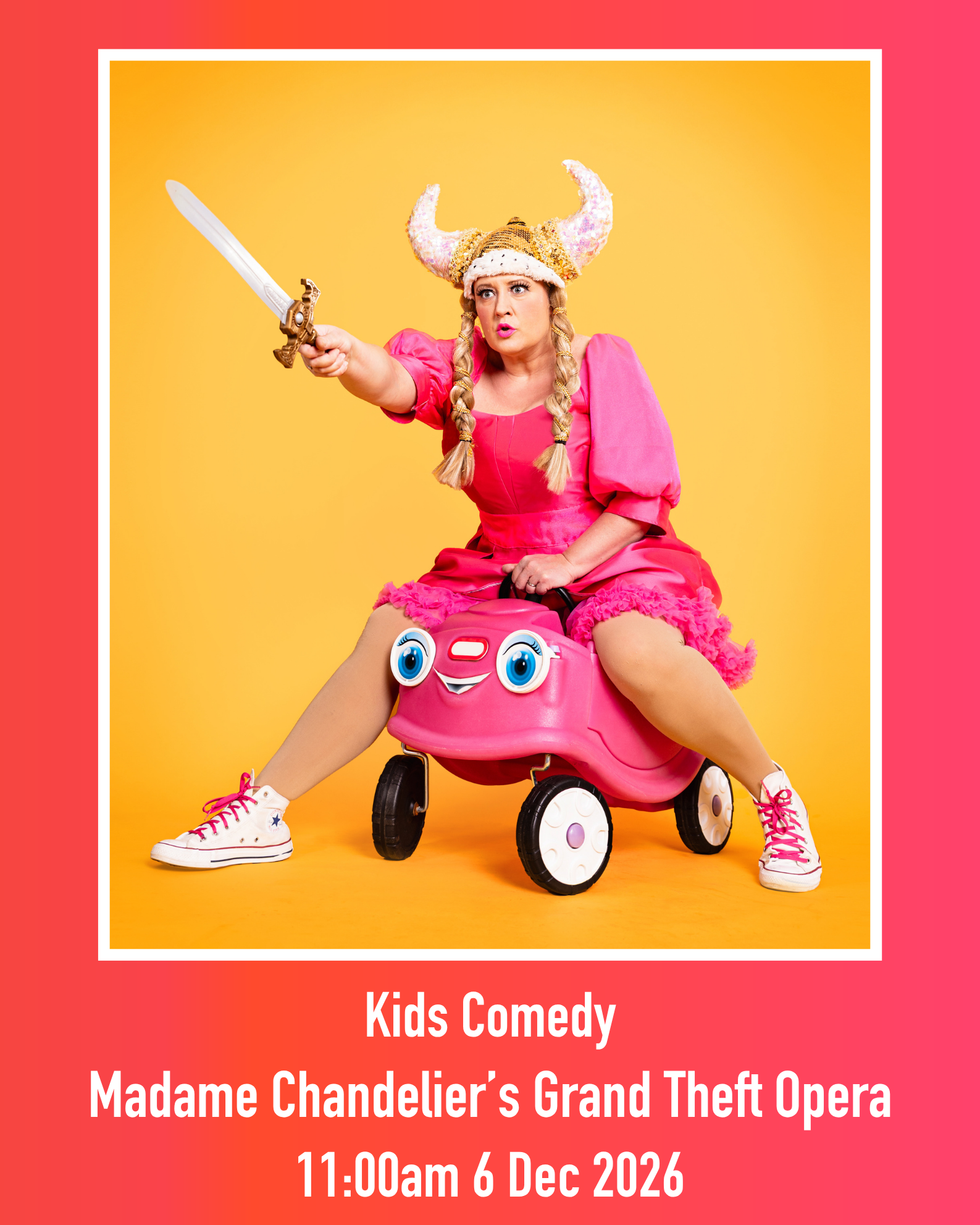 Poster featuring adult comedy character dressed in pink, wearing a horned helmet and bearing a sword, whilst riding a child's pink push-along car.